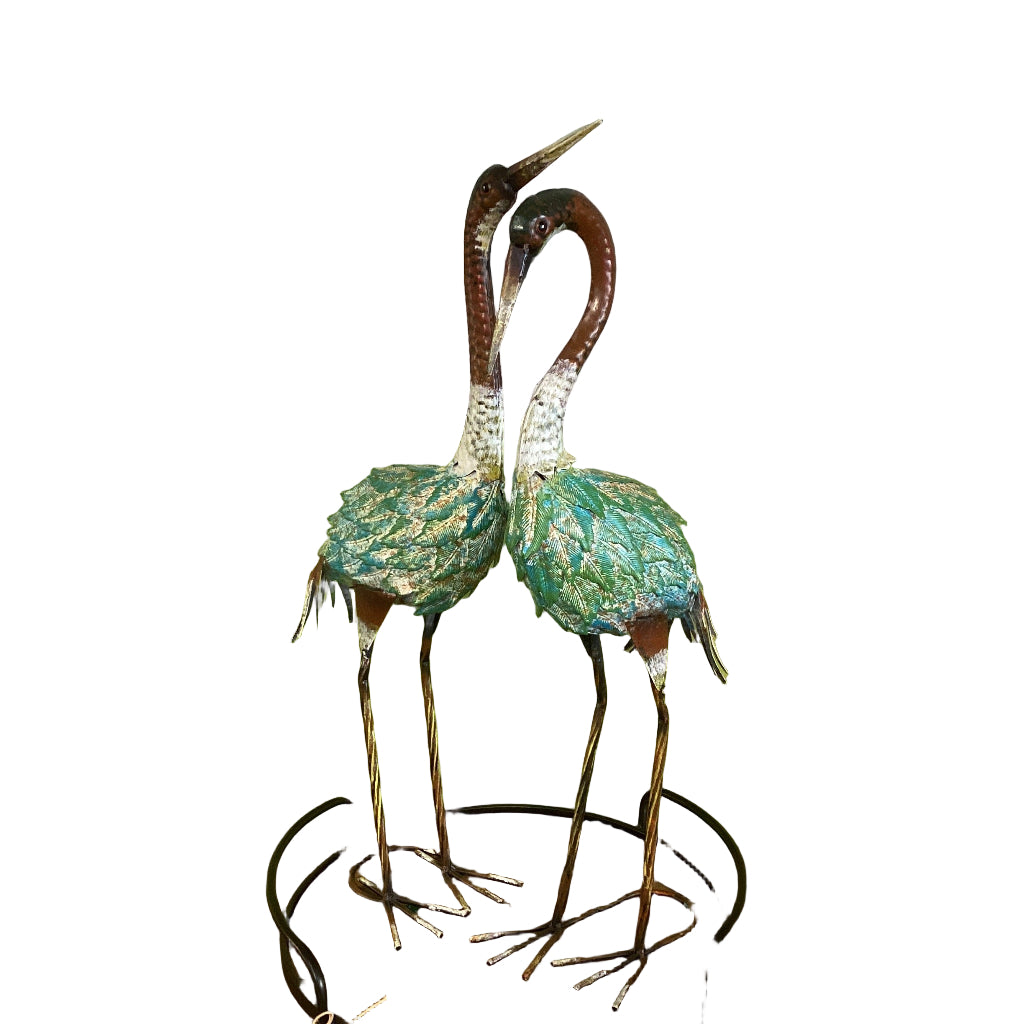 Decorative cranes on a stand with a painting and discount sign in the background.