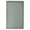 Green and white patterned rug on a white background