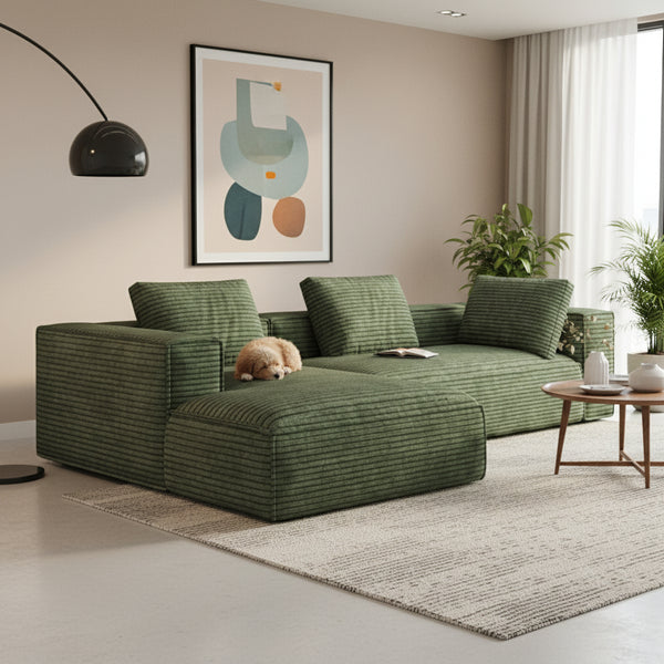 Green sofa in a modern living room with abstract art and a checkered rug.